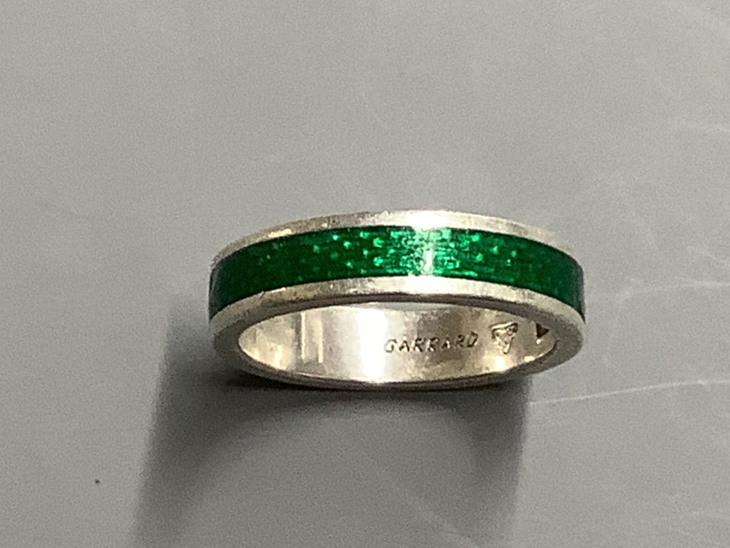 A Garrard's modern silver and green enamel band,